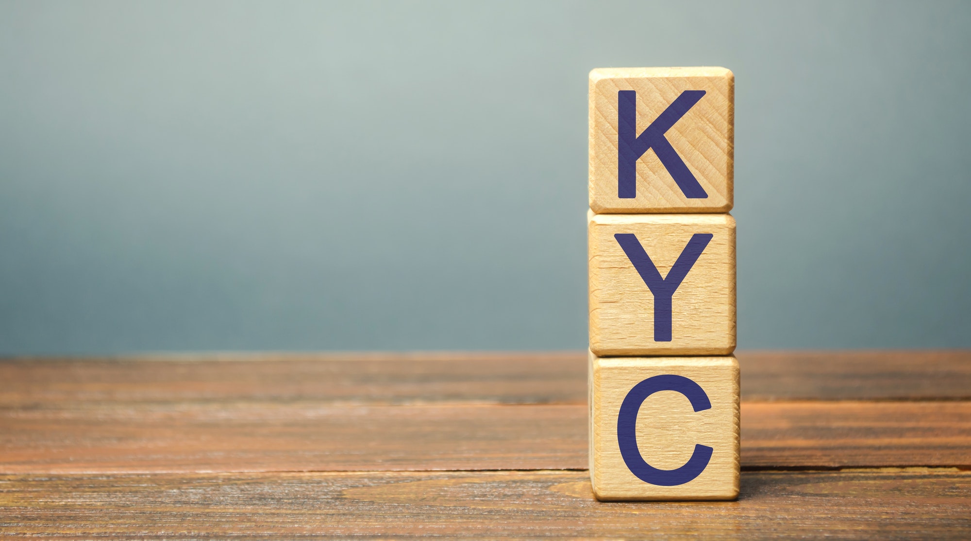 Wooden blocks with the word KYC - Know Your Customer / Client.