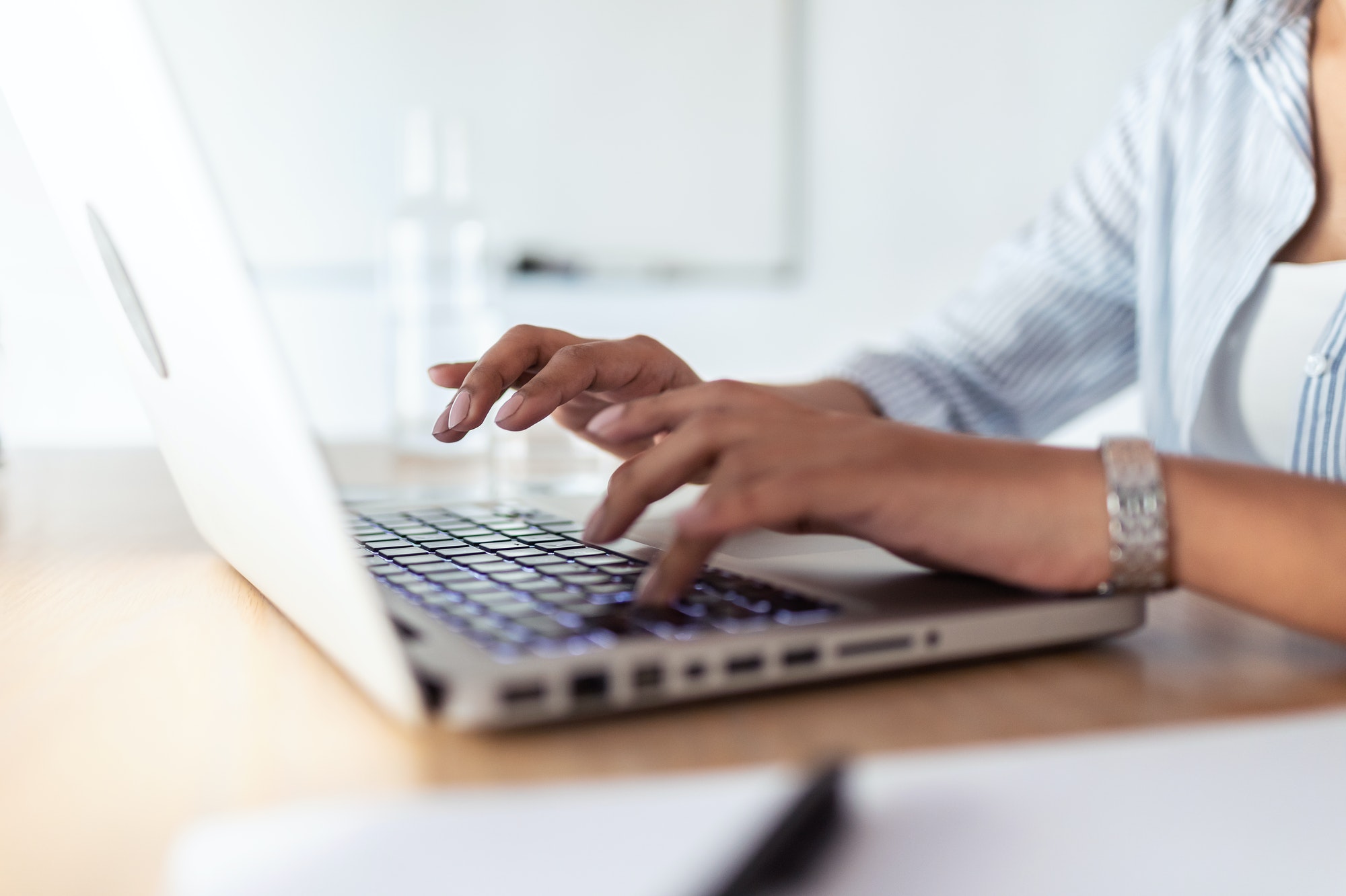 Elegant young business woman working with her laptop in the office.